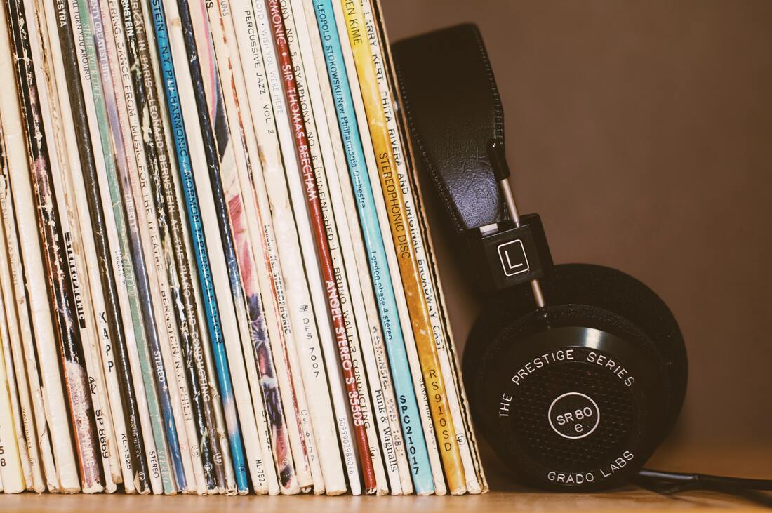 headphones resting against a stack of records